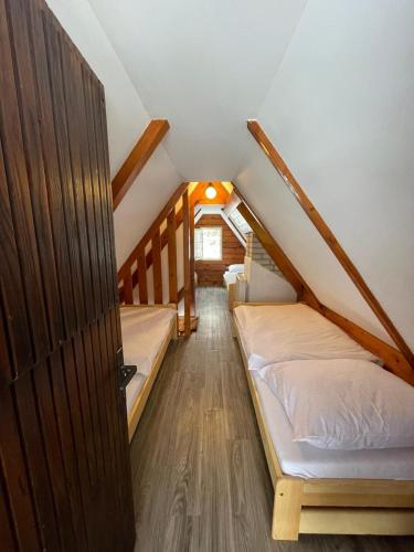 a room with two beds in a attic at Ubytování Doubice in Doubice