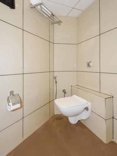 a bathroom with a toilet and a toilet paper dispenser at Hotel Zillion Executive Near US Consulate Bandra Kurla Complex Mumbai Near Mumbai Airport Mumbai in Mumbai