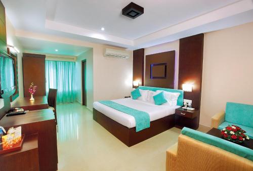 a hotel room with a bed and a couch at HOTEL SRIVATSA REGENCY in Pudunagaram