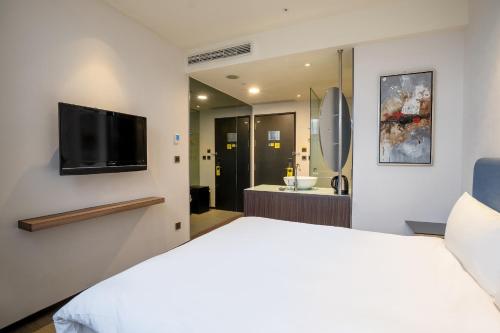 Ένα ή περισσότερα κρεβάτια σε δωμάτιο στο CHECK inn Taipei Xinyi