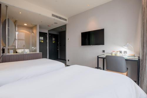 Ένα ή περισσότερα κρεβάτια σε δωμάτιο στο CHECK inn Taipei Xinyi