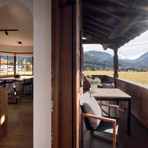 a view from the balcony of a house with a table and chairs at activechalets six.nine.eight in Reit im Winkl