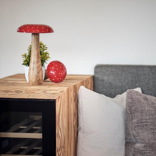 a wooden table with a mushroom on top of it at activechalets six.nine.eight in Reit im Winkl