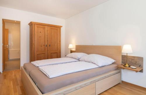 a bedroom with a large bed with two pillows at Ferienwohnung Spannring in Schruns