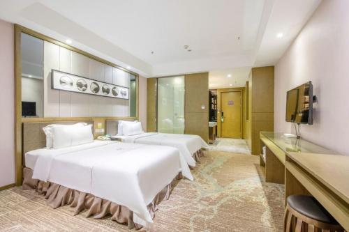 Ένα ή περισσότερα κρεβάτια σε δωμάτιο στο lnsail Hotel Shenzhen Luohu Port Railway Station