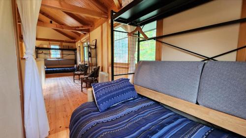 a bedroom with a bed in a tiny house at VILLA SHINANO in Shinano