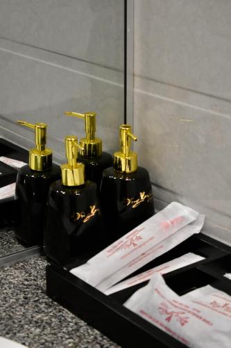 a group of three perfume bottles sitting on a counter at Đông Xuyên Hotel in Long Xuyên
