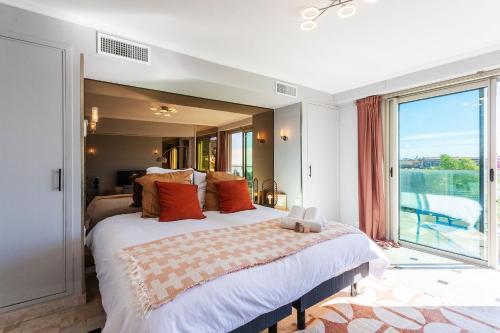 une chambre avec un grand lit avec une grande fenêtre dans l'établissement PLAZA TERRACE AP4065 by RIVIERA HOLIDAY HOMES, à Nice