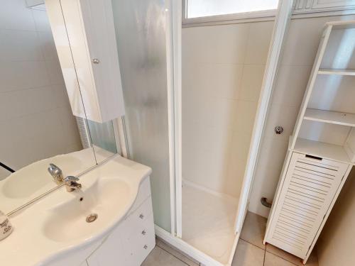 une salle de bain blanche avec une douche et un lavabo dans l'établissement Studio climatisé avec terrasse face à la mer - FR-1-196-346, à Menton