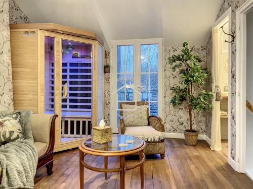 a living room with a couch and a table at La Romantique des Rois # Jacuzzi # Sauna in Dourdan