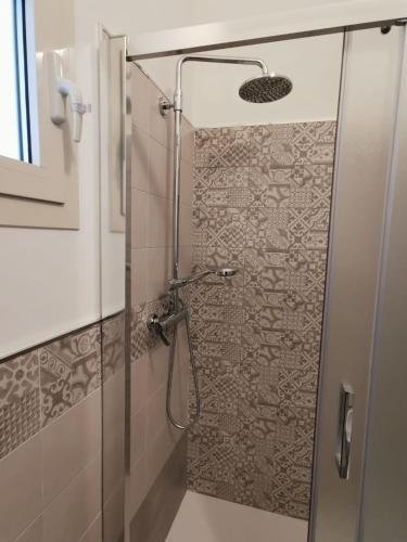 a shower with a glass door in a bathroom at La Casa dei Gigli in Lecce