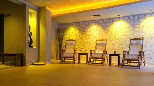 a room with chairs and tables and a wall with mirrors at Renka Hotel & Spa in Göcek