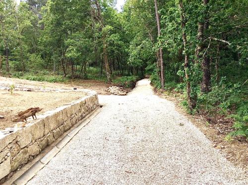 a dirt road in the middle of a forest at CASA TAPADA DA CHEDA 2 in Celorico de Basto
