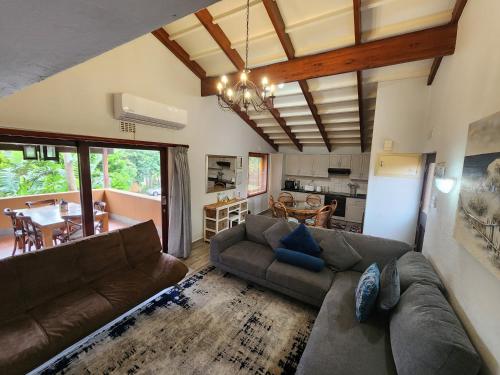 a living room with a couch and a dining room at San Lameer Villa 2012 in Southbroom