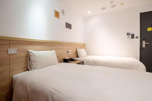 Ένα ή περισσότερα κρεβάτια σε δωμάτιο στο CHASE Hotel