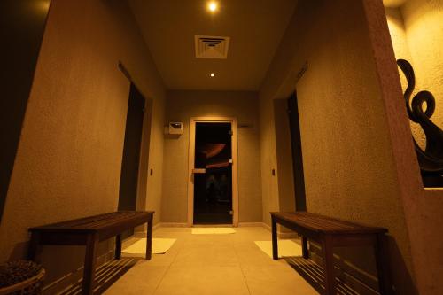 two benches sitting in a hallway with a hallway at Renka Hotel & Spa in Göcek