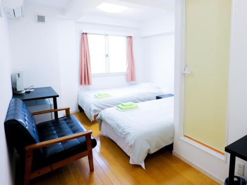 En eller flere senge i et værelse på ホテル中央セレーネ Hotel CHUO SELENE