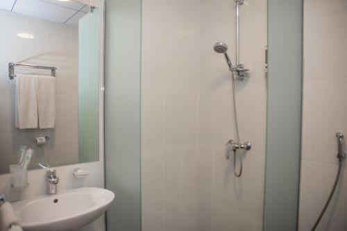 a bathroom with a shower and a sink at Cascade Hotel in Yerevan