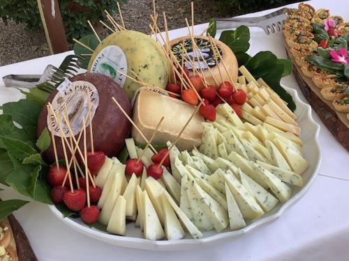 a plate of cheese and fruit on a table at Antica Fattoria La Parrina in Orbetello