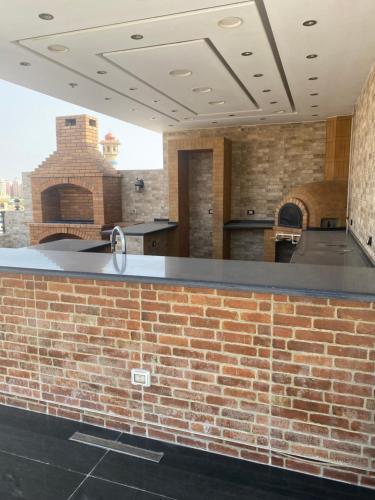 a brick bar in a kitchen with a brick wall at black tiger villa in ‘Ezbet `Abd el-Ḥamîd