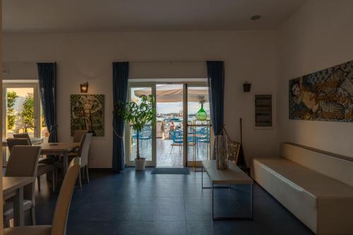 a restaurant with tables and chairs and a view of the ocean at Baia Flegrea Meublè in Bacoli