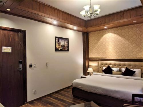 a hotel room with a bed and a door at The Retreat Mashobra, Shimla in Shimla