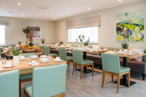a dining room with a long table and chairs at The Charm Brighton Boutique Hotel & Spa in Brighton & Hove
