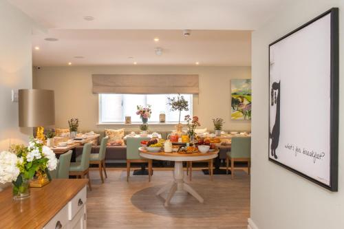 a dining room with a table with food on it at The Charm Brighton Boutique Hotel & Spa in Brighton & Hove