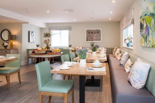 a dining room with a couch and a table and chairs at The Charm Brighton Boutique Hotel & Spa in Brighton & Hove