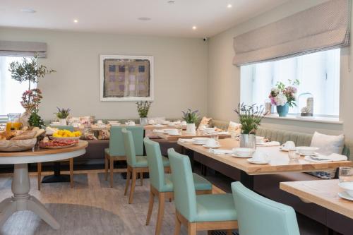 a dining room with a long table and chairs at The Charm Brighton Boutique Hotel & Spa in Brighton & Hove