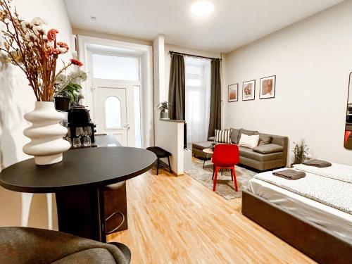 a living room with a bed a table and a couch at T32 Central Modern Suites in Budapest