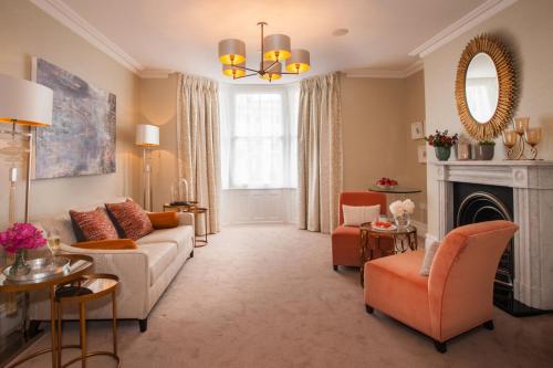 a living room with a couch and a fireplace at The Charm Brighton Boutique Hotel & Spa in Brighton & Hove