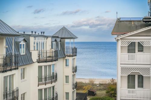 a view of the ocean from between two buildings at Villa Sommerfreude in Bansin