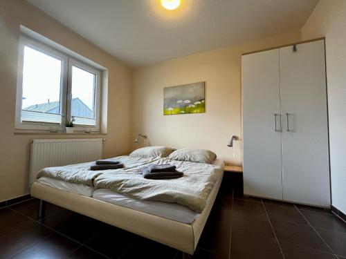 a bedroom with a bed and a large window at Ferienhaus Strandräuber in Zierow