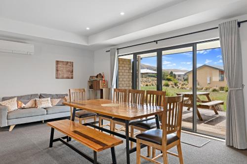 a living room with a wooden table and chairs at Hunter 3 Bedroom Apartment C in Lake Tekapo
