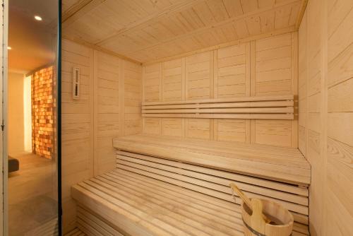 a sauna with wooden walls and a wooden bench at KOIA All - Suite Well Being Resort - Adults Only in Agios Fokas