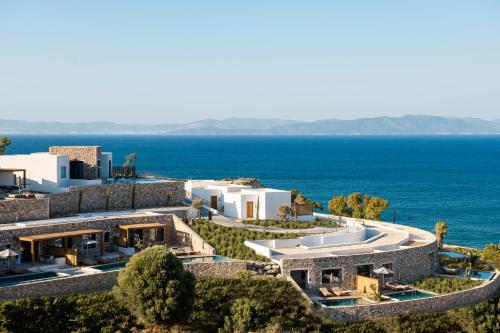 an aerial view of a building with the ocean in the background at KOIA All - Suite Well Being Resort - Adults Only in Ágios Fokás