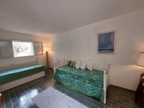 a small bedroom with a bed and a window at Fetovaia Magic Holiday Villa in Fetovaia
