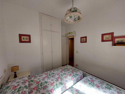 a bedroom with a bed with a floral bedspread at Fetovaia Magic Holiday Villa in Fetovaia