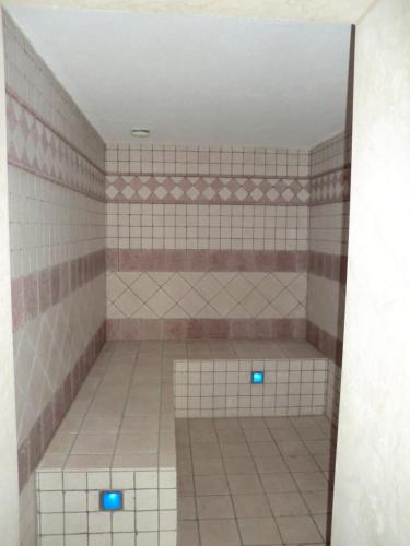 a tiled bathroom with two blue lights in it at The Cosy Home in Hodenhagen