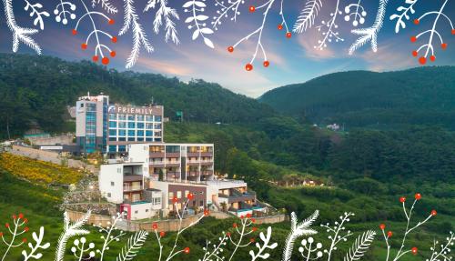 a building on the side of a hill with trees at Friemily Pool Villa & Hotel in Geoje 
