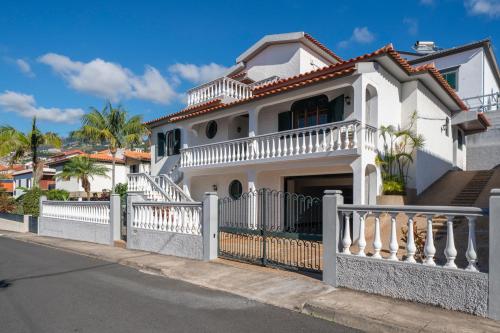 a white house with a white fence at OurMadeira - BelleVeva in Funchal