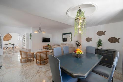 a dining room and living room with a table and chairs at OurMadeira - BelleVeva in Funchal