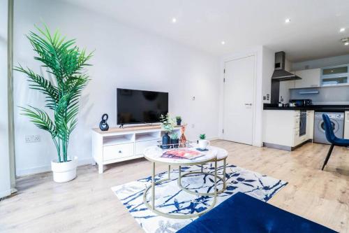 a living room with a table and a tv at Canary Wharf-10% discount-Fibre Wifi-5mins to Tube in London