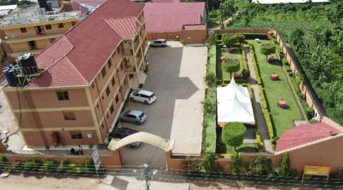 an aerial view of a large building with a yard at PRIMEROSE HOTEL in Mubende