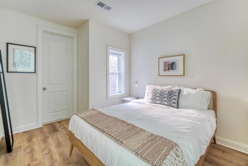 a bedroom with a bed with white sheets and a window at Dupont Circle 1br w wd nr bars metro station WDC-750 in Washington, D.C.