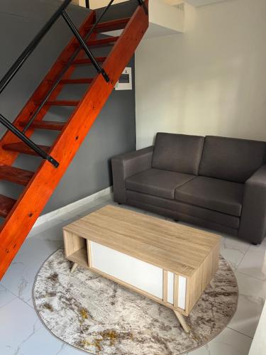 a living room with a couch and a coffee table at Unit 76 Melville Mews in Johannesburg