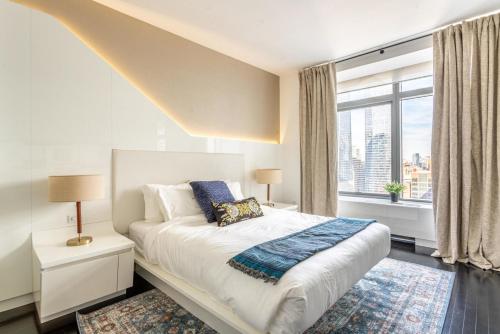 a bedroom with a bed and a large window at Financial District w WD gym elevator NYC-1360 in New York