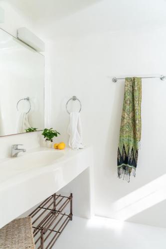 a white bathroom with a sink and a mirror at Villa Crystal by Mykonos Mood in Fanari