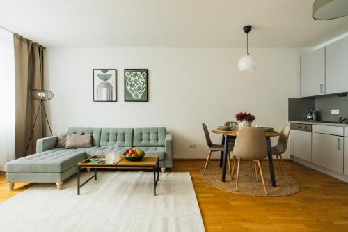 a living room with a couch and a table at Business & Family Ambiente Apartments in Bratislava